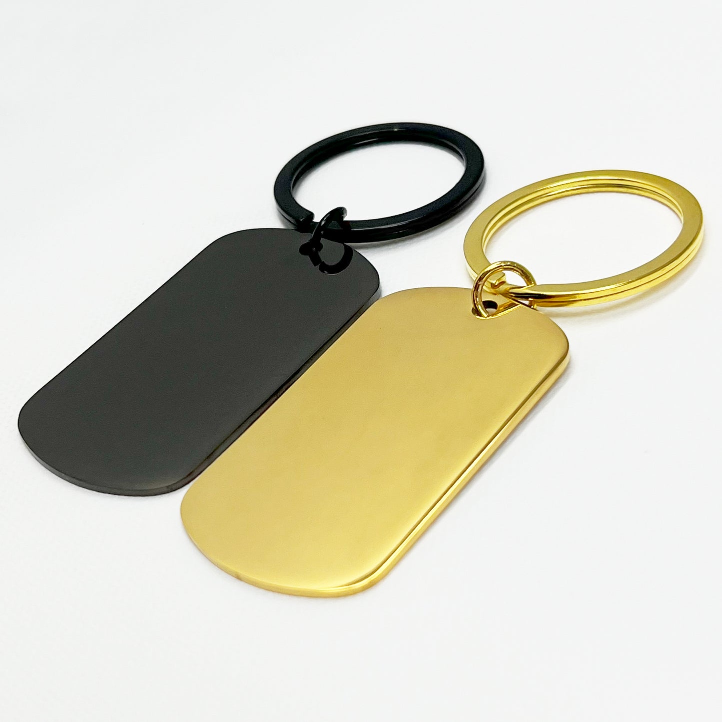 Engraved black and gold oval keychains in an elegant black gift box β A memorable custom gift set