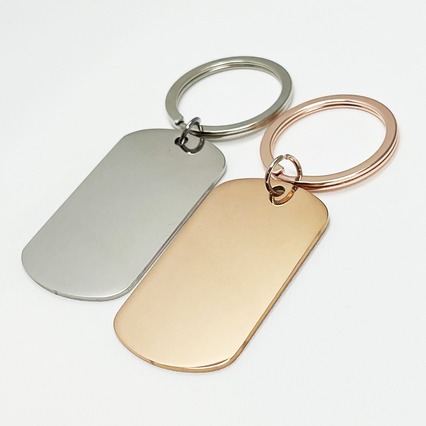 Stylish silver and rose gold oval keychains in a modern black gift box β Custom engraved keepsakes